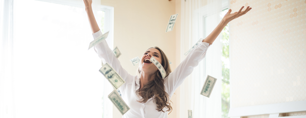 Woman with dollar bills on the bed